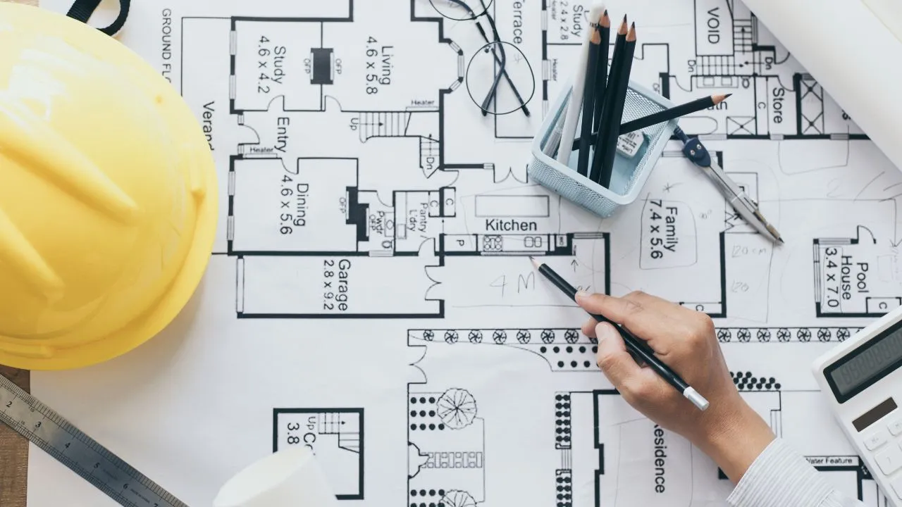 an engineer working on a floor plan