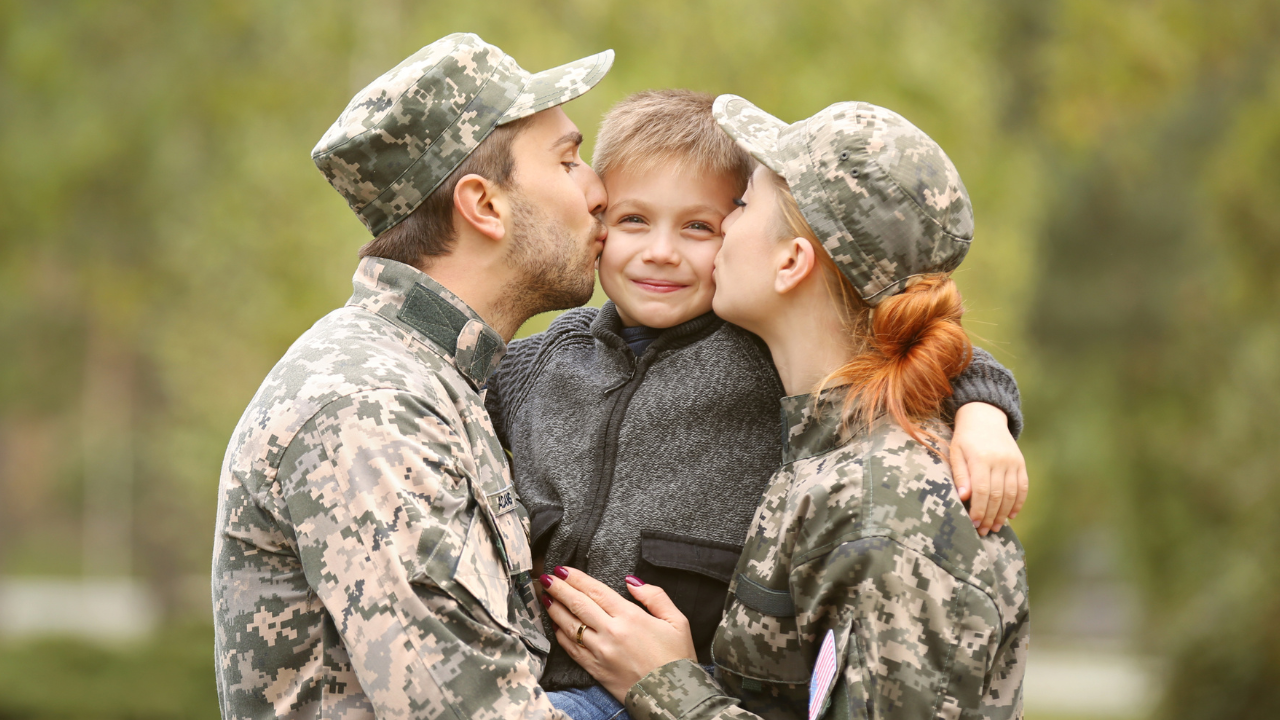 A military couple embracing their child