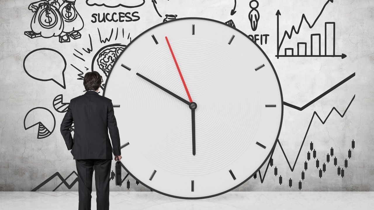 A man standing in front of a clock