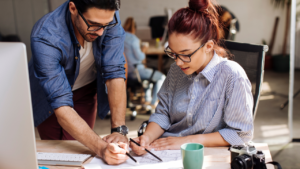 Two people working in their office