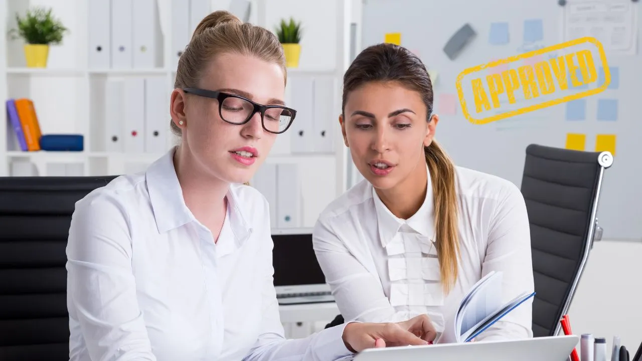 Two production company entrepreneurs working in office