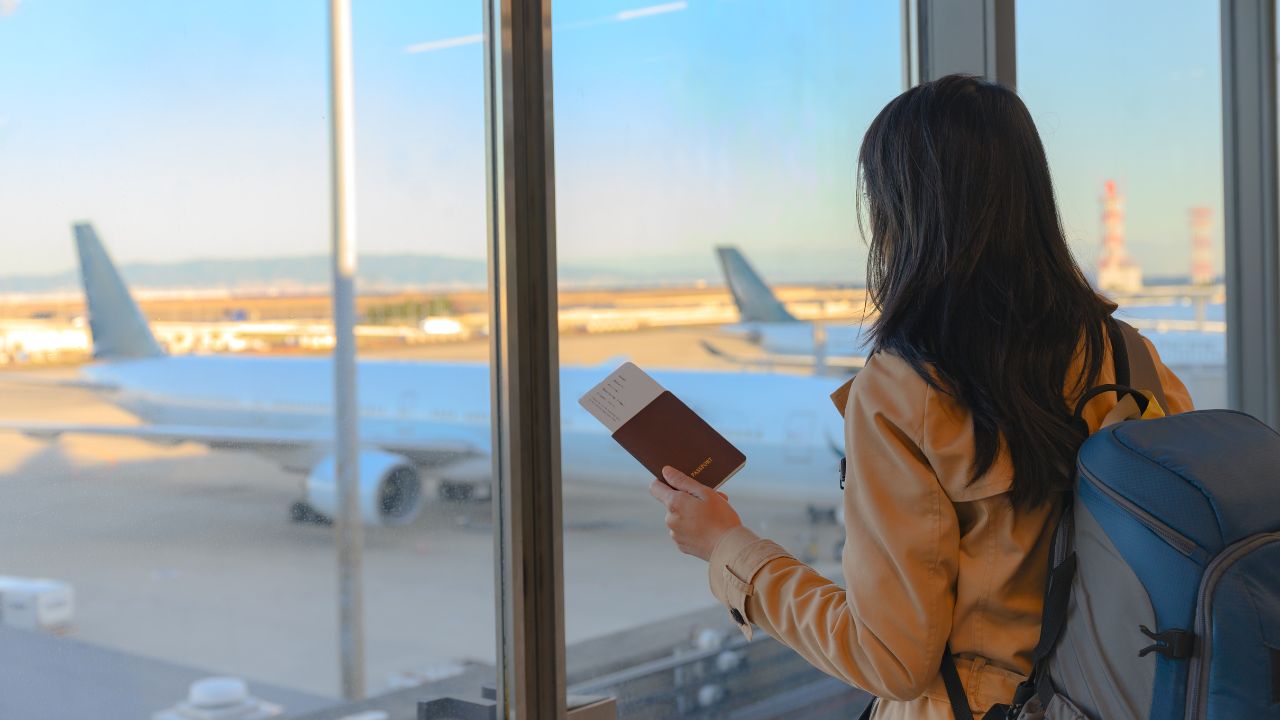 A woman at the airport waiting for her flight to board