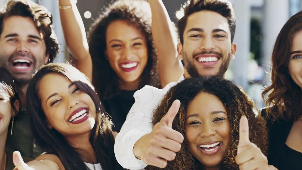 a group celebrating with a thumbs up