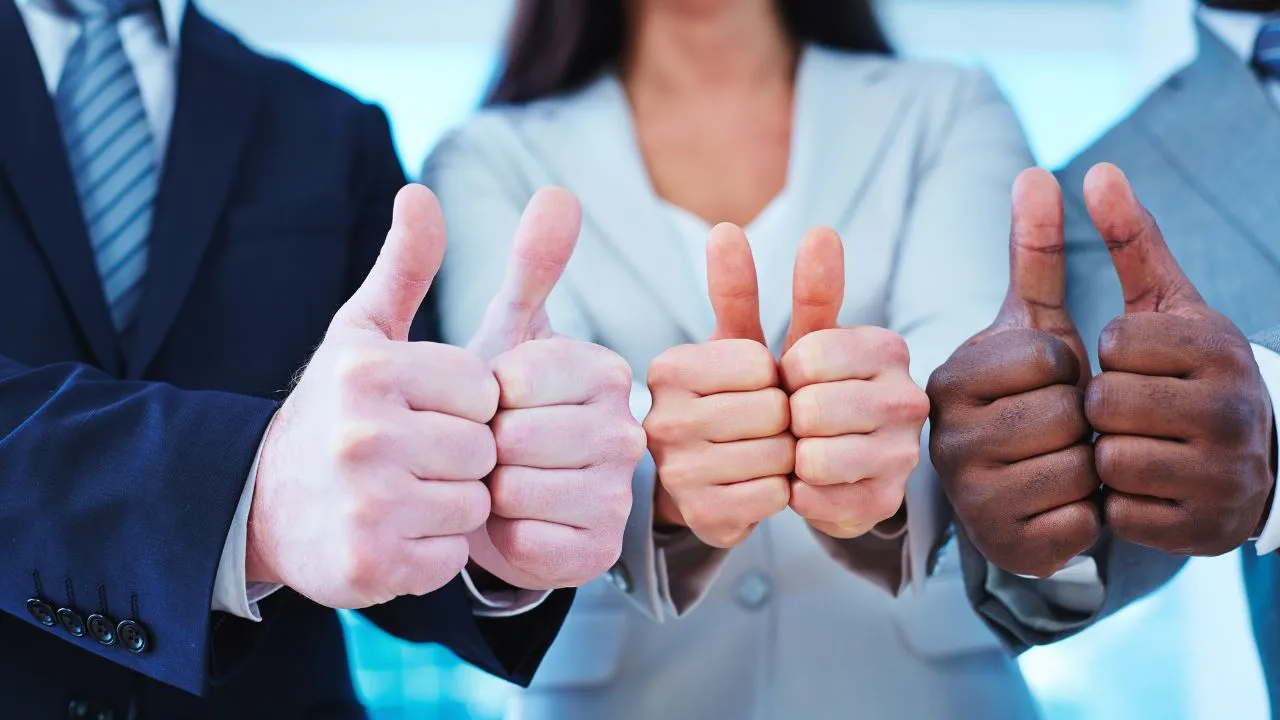 Three people doing thumbs up