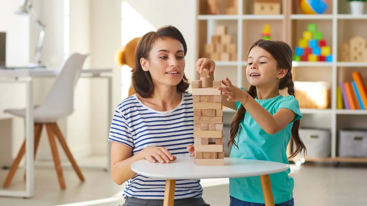 A nanny playing with a child