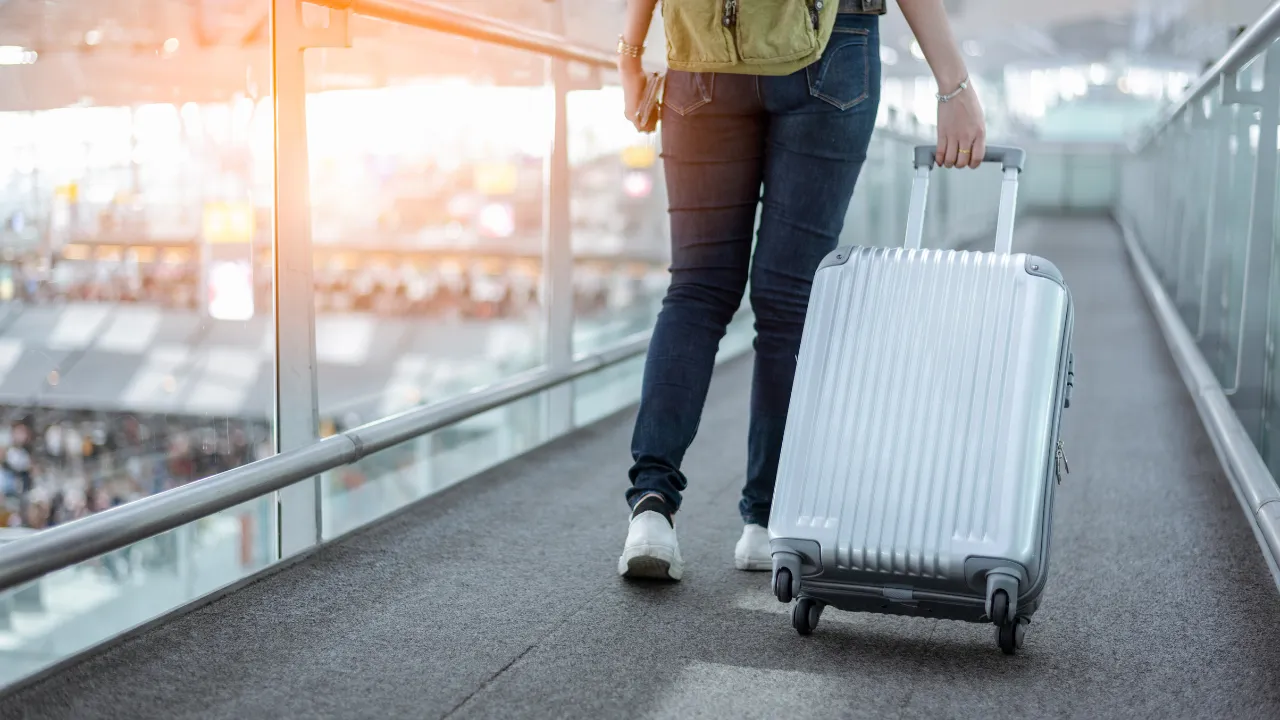 A person with a suitcase at the airport
