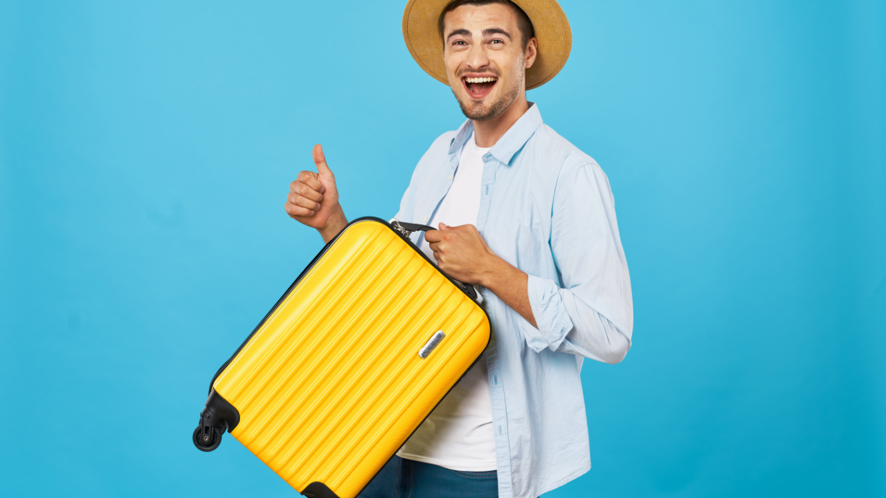 A man holding his suitcase and happy to travel