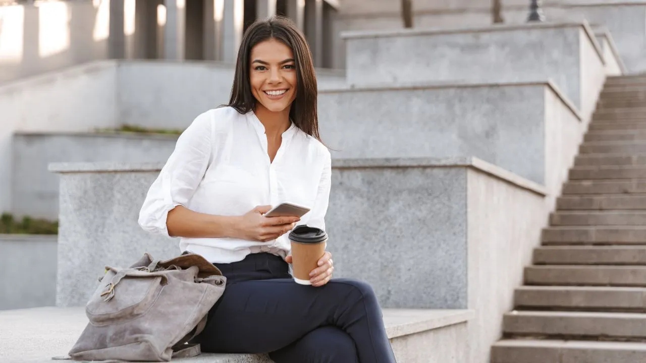 A happy business owner sitting outside
