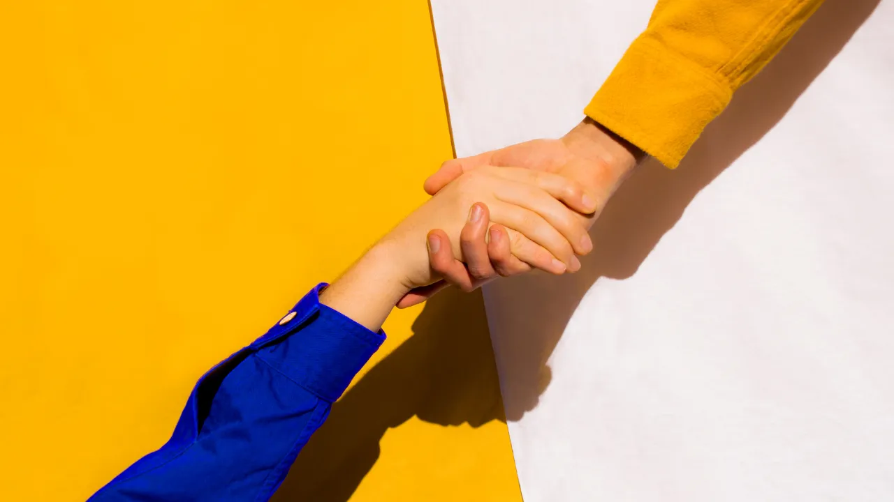 A helping hand being offered from one person to another