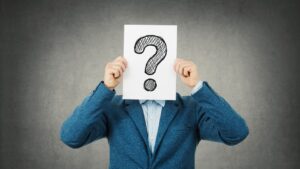 A man holding a question mark