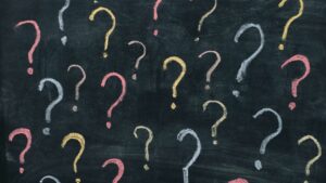 A chalk board of question marks