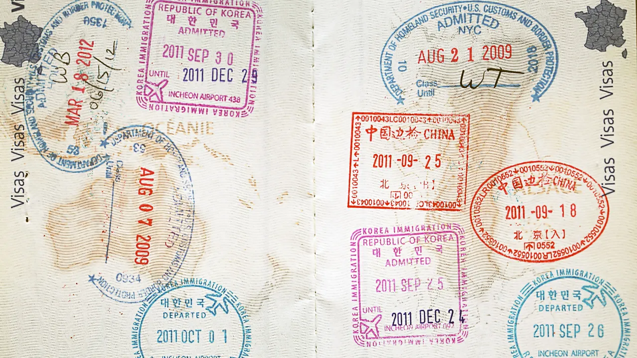 A passport full of travel visas and stamps