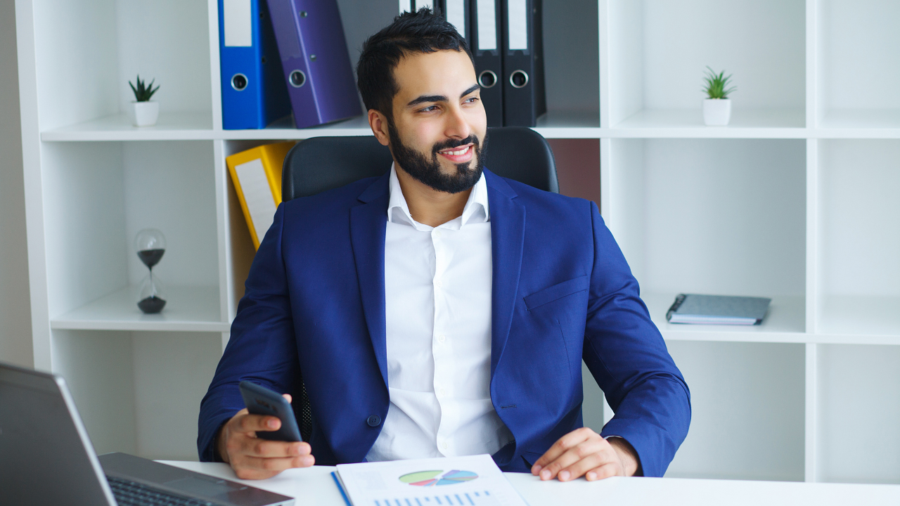 A self employed man sitting at his desk