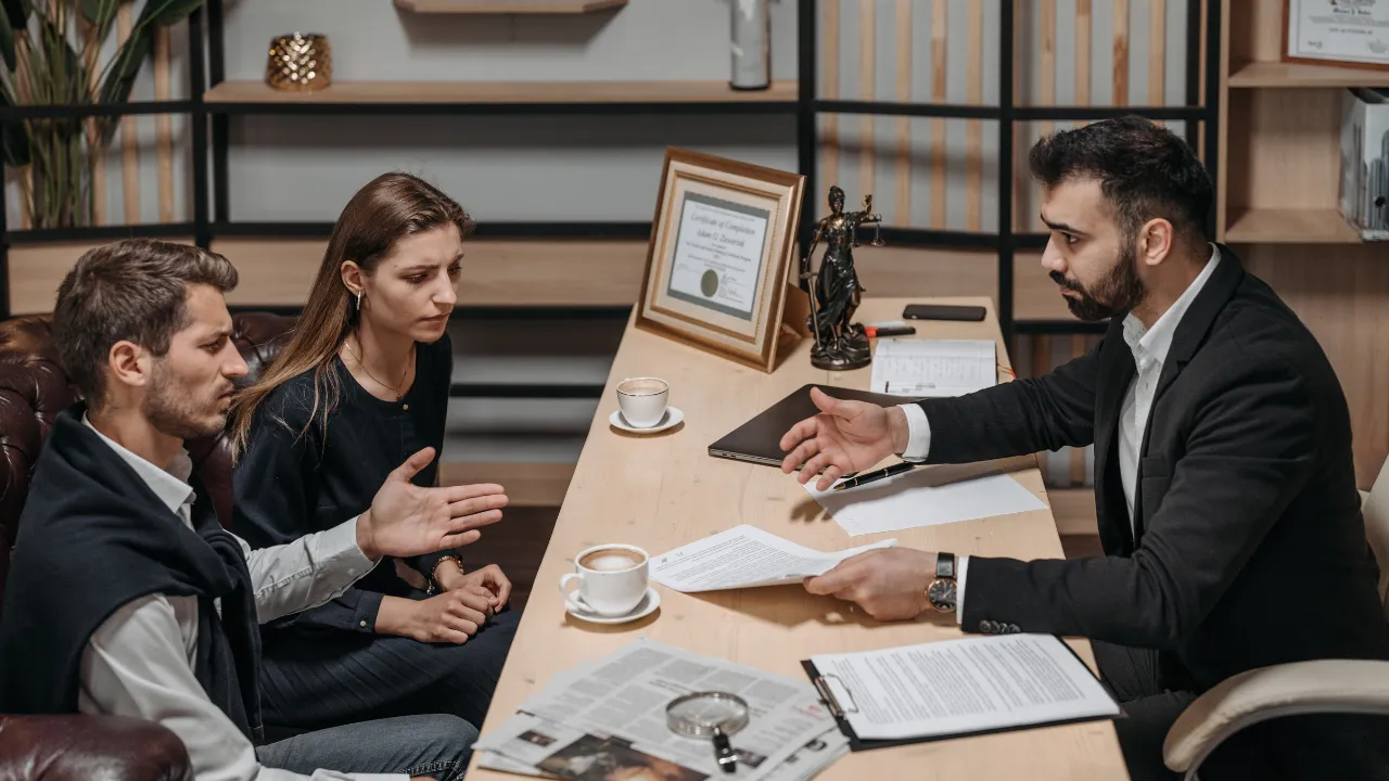 A lawyer and clients looking at criminal convictions