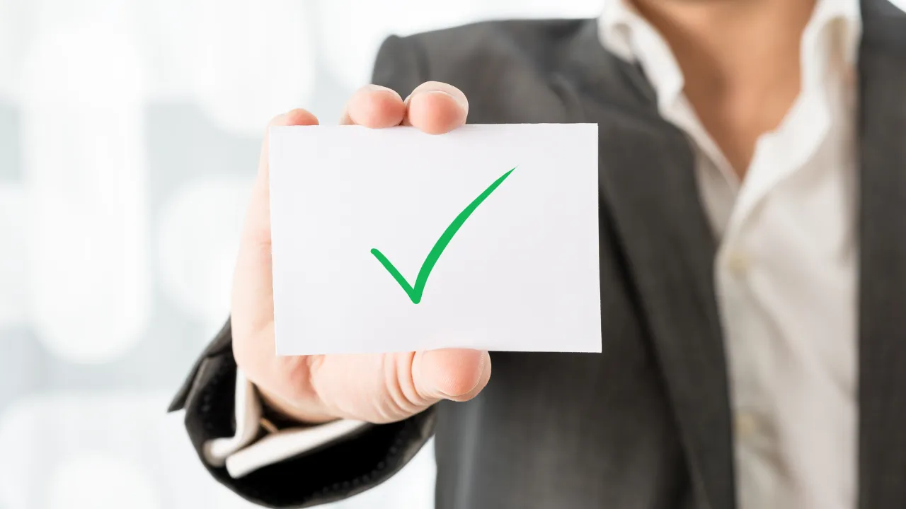 A professional holding a checkmark