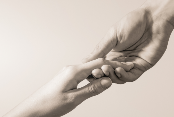 Two people holding their hands out to each other