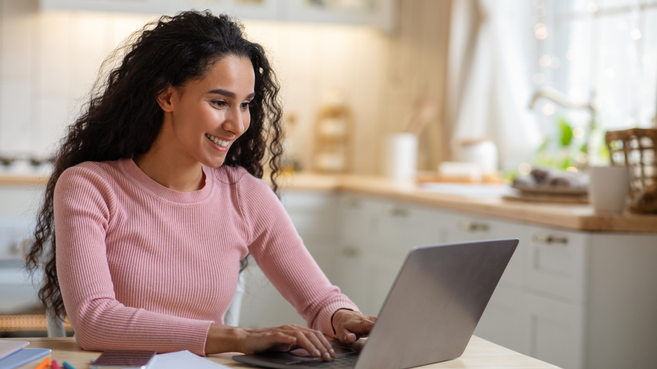 A woman considering her E2 options on her laptop