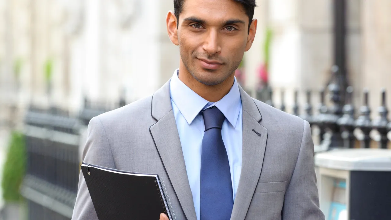 A business man holding a clipboard