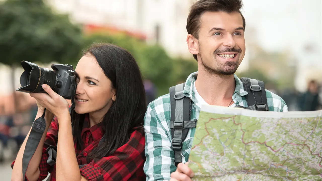 Two tourists with a camera and map