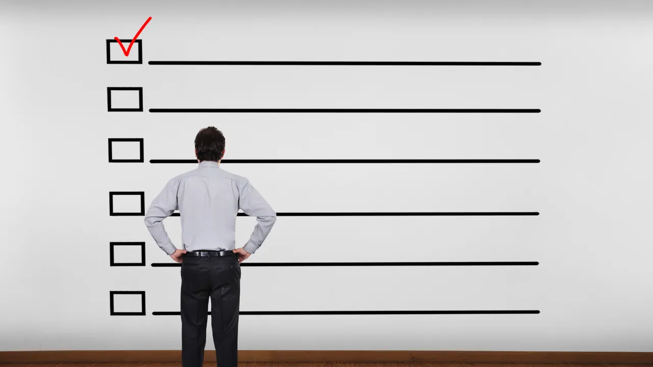 A man looking at a guide/checklist