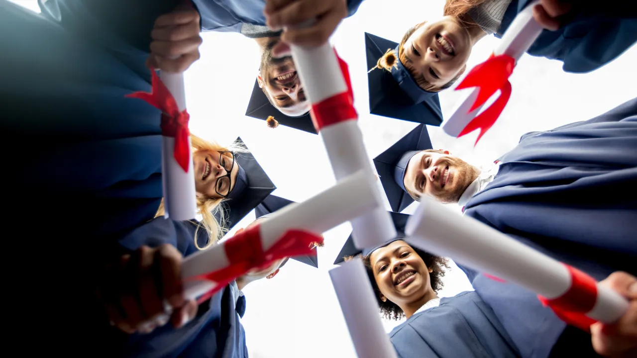 A group of graduates holding their bachelor degree