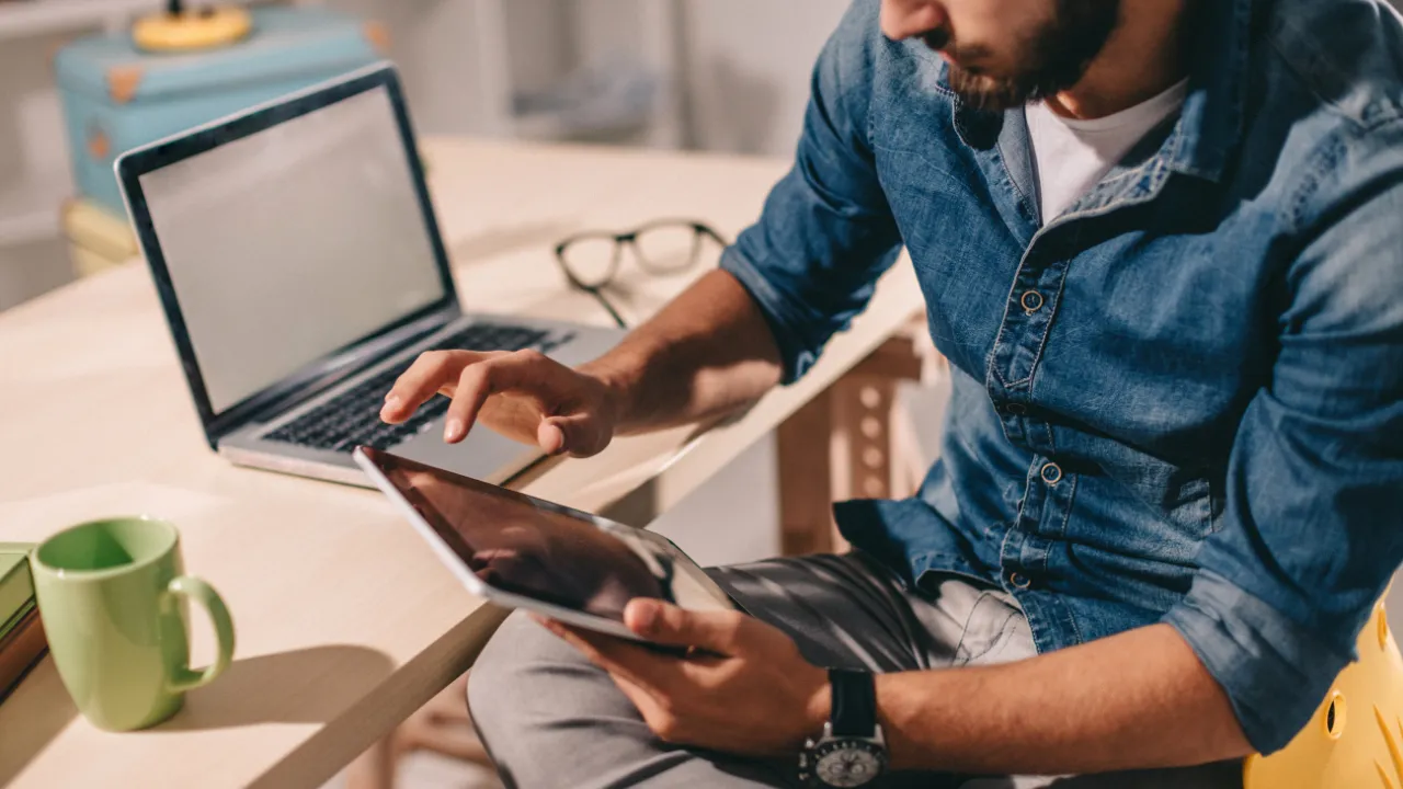 A man reading news updates on his tablet