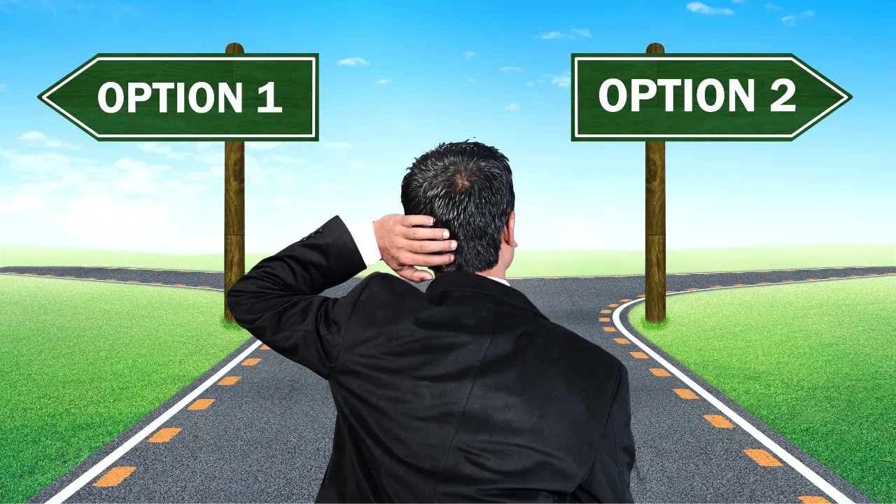 A man looking at two different pathways, wondering which he should take