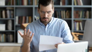 A man looking at a motion to dismiss with frustration