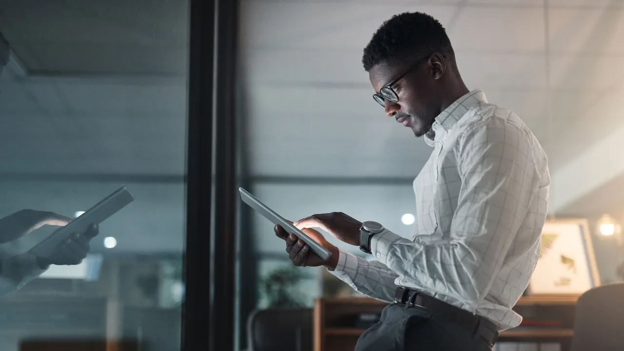 A business professional considering their business options on a tablet in front of them