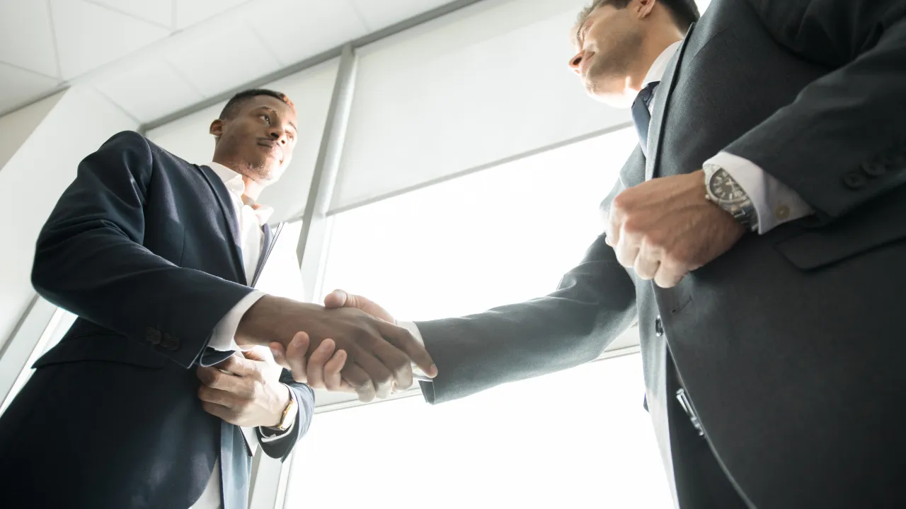 Two investors shaking hands