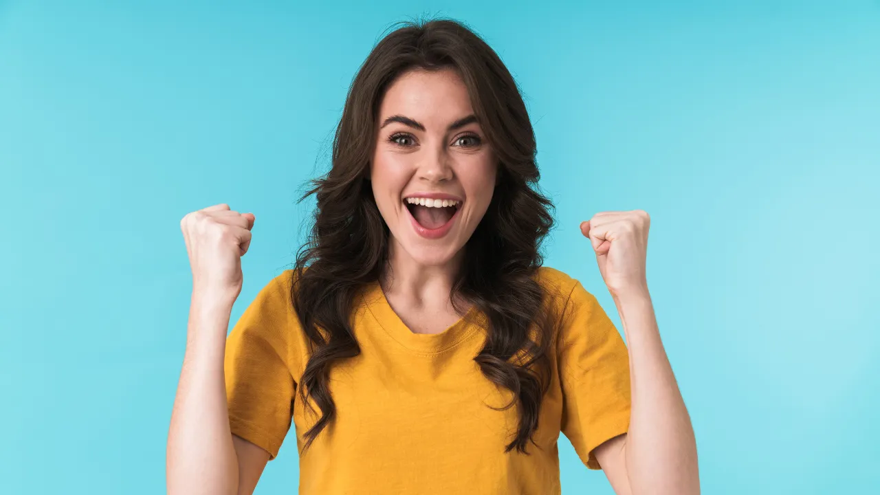 A woman celebrating being selected in the diversity visa lottery