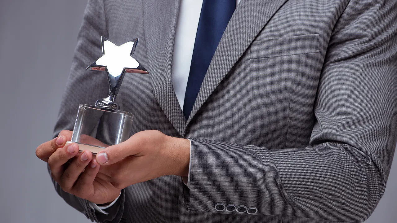 A professional holding an award