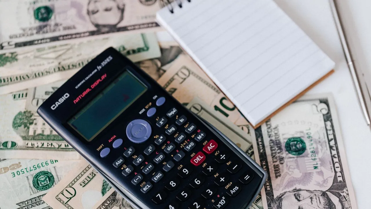 fees, a calculator and notepad with pen