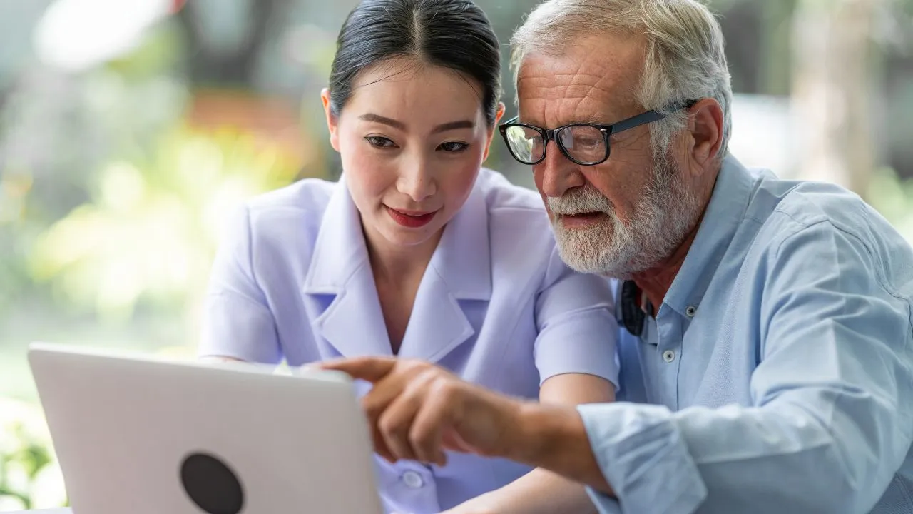 Two individuals figuring out their options on their laptop