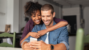 A happy couple looking at a recent green card approval