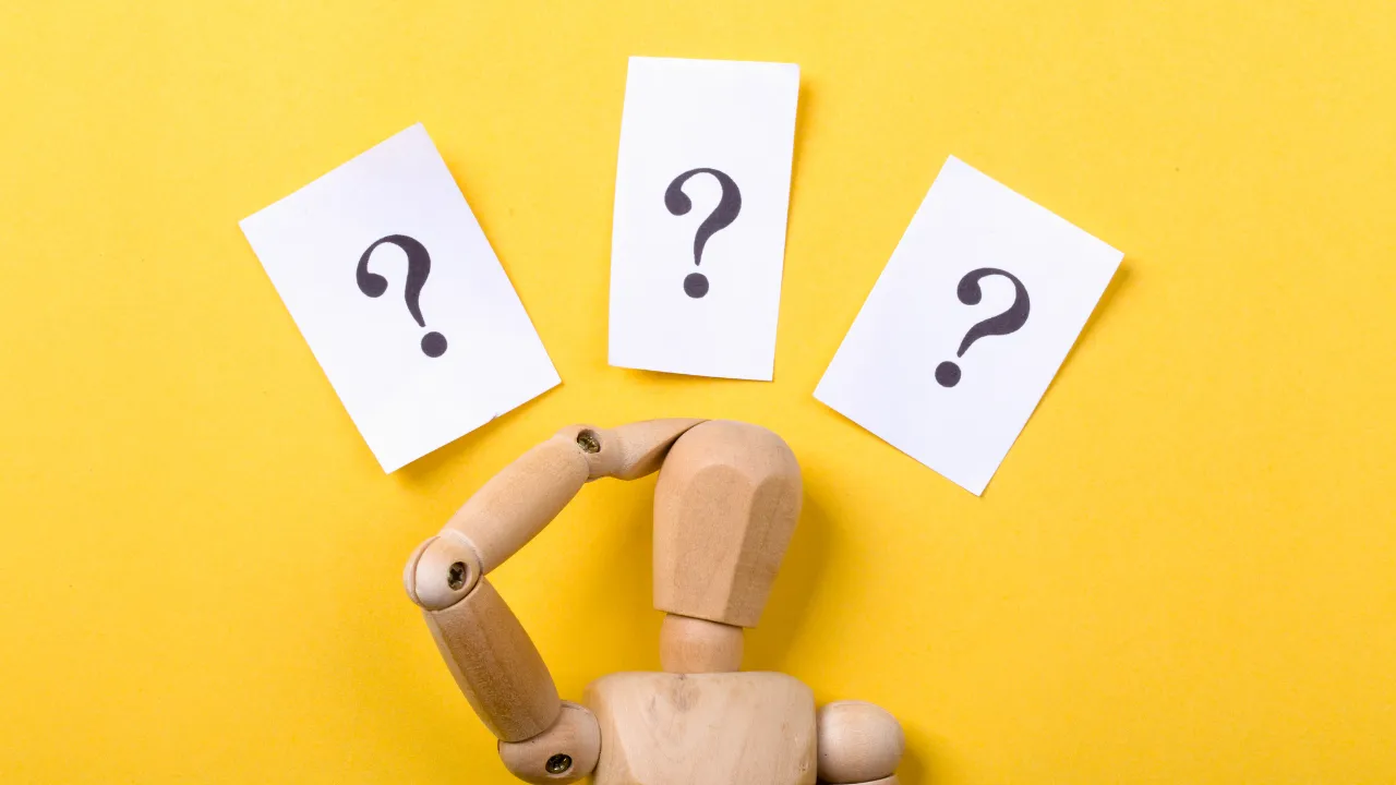 A bunch of questions above a stick figure.