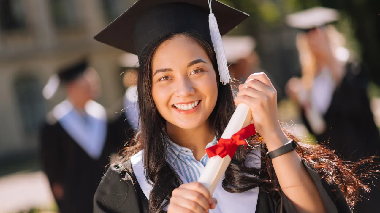 A student holding a graduate degree