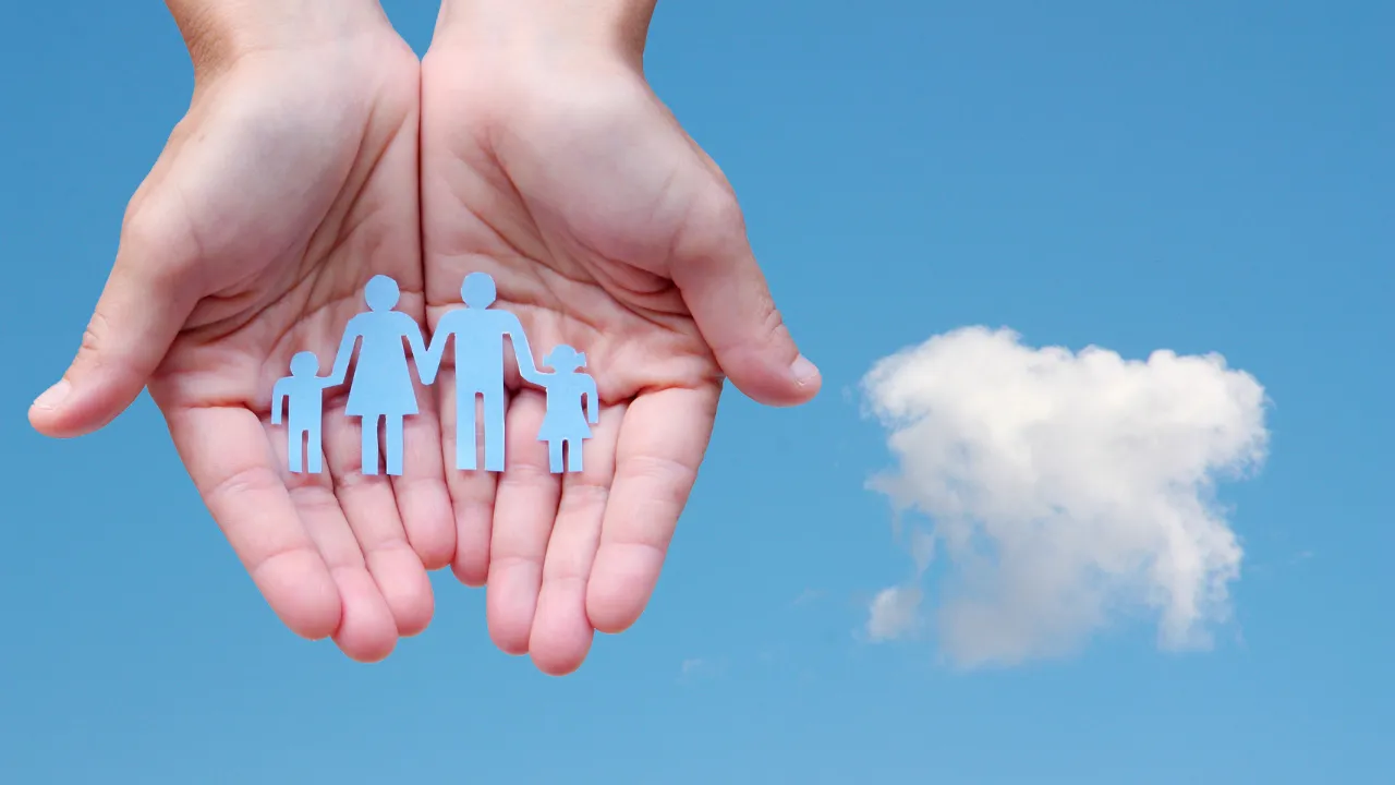 A hand holding a family