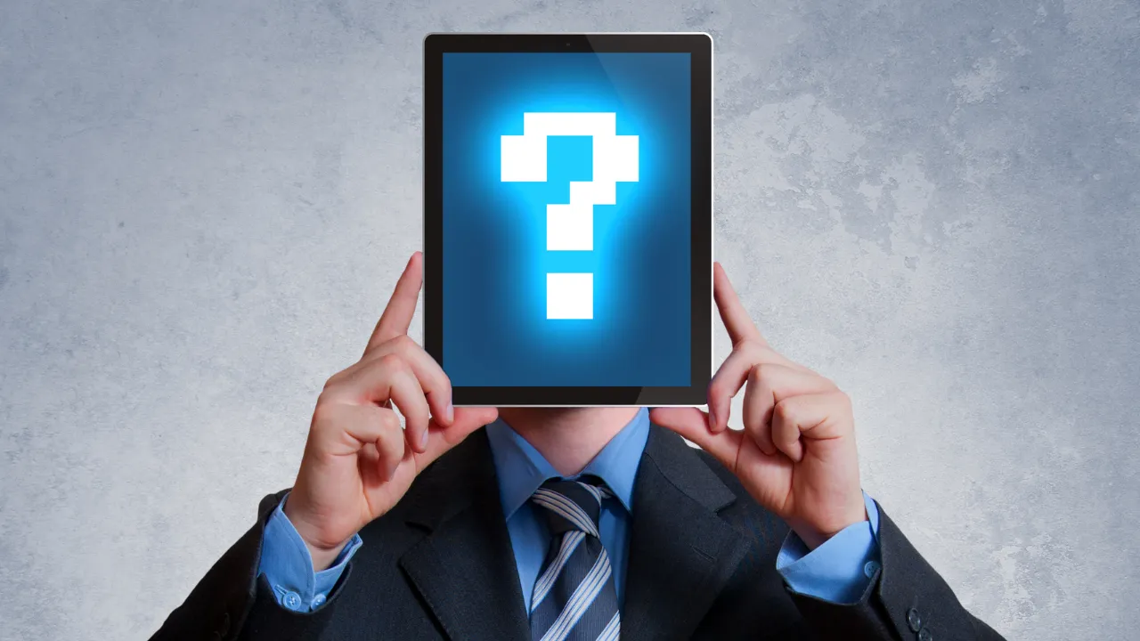 A corporate man holding a question mark