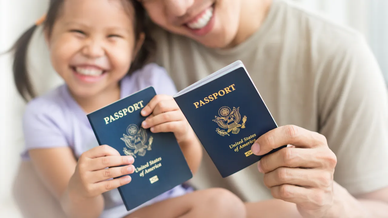 A family holding up their passports