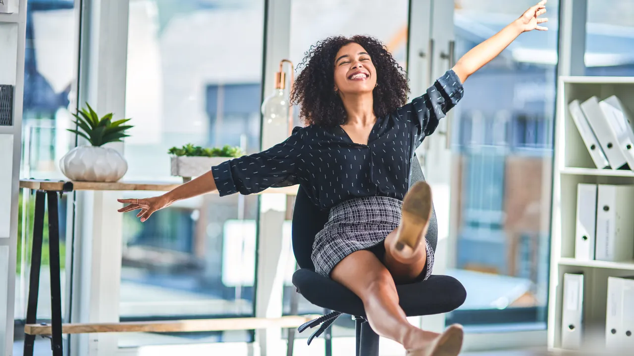A woman celebrating being successful and succeeding.
