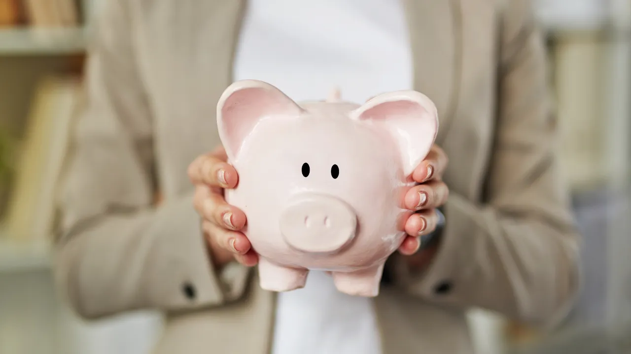 a woman holding a piggy bank