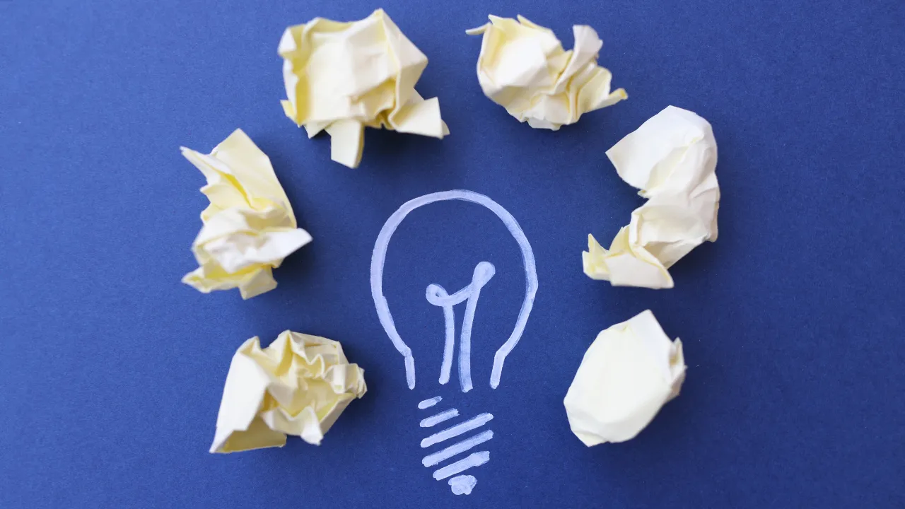 A lightbulb with sticky notes around it