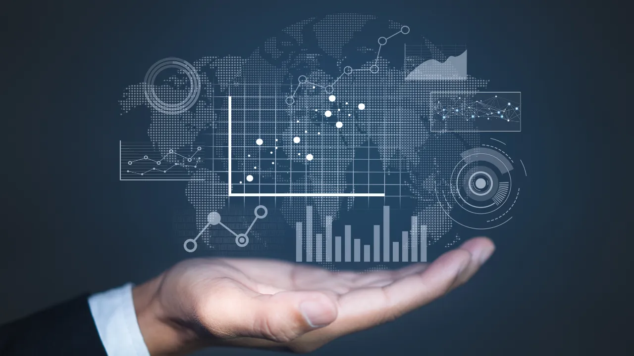 A hand holding a group of systems and graphs