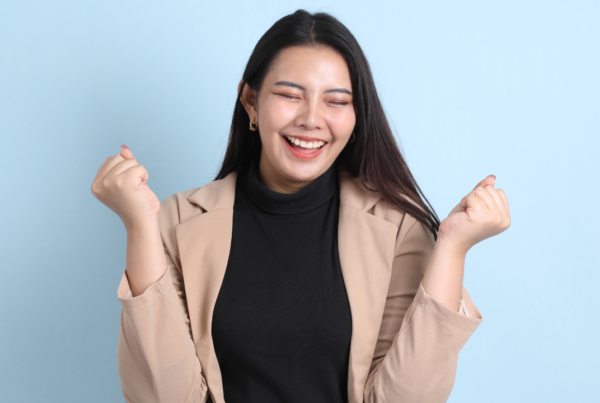 A woman celebrating a win | Scott Legal, P.C. A woman celebrating a win