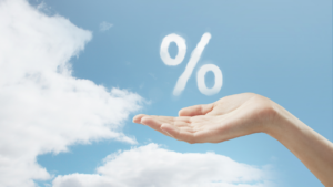 A hand holding a percentage sign in the clouds