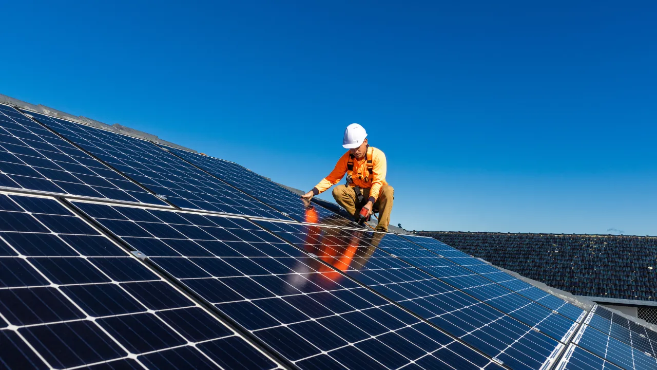 A man installing solar panels