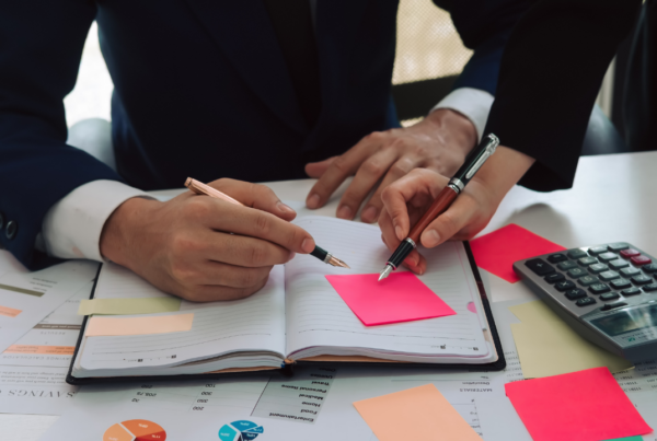 Two professionals consulting their agenda | Scott Legal, P.C. Two professionals consulting their agenda