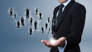 A collection of potential employees held in the hand of an employer