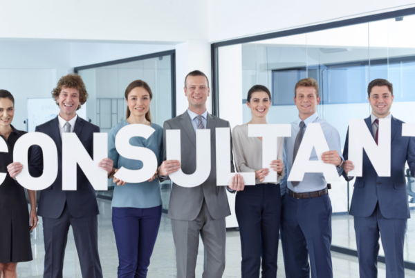 consultant sign being held by group of professionals